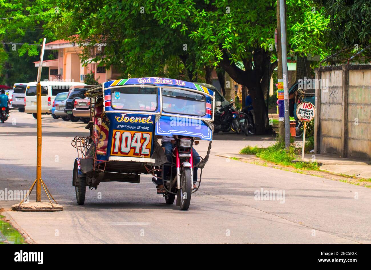 Dumaguete, Philippines - 13 May, 2017: National Philippine transport tricycle on city street. Tourist transport. Transport traffic in Philippines. Tra Stock Photo