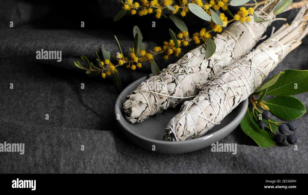 Dried white sage smudge stick, relaxation and aromatherapy. Smudging during psychic occult ceremony, herbal healing, yoga or aura cleaning. Essential Stock Photo