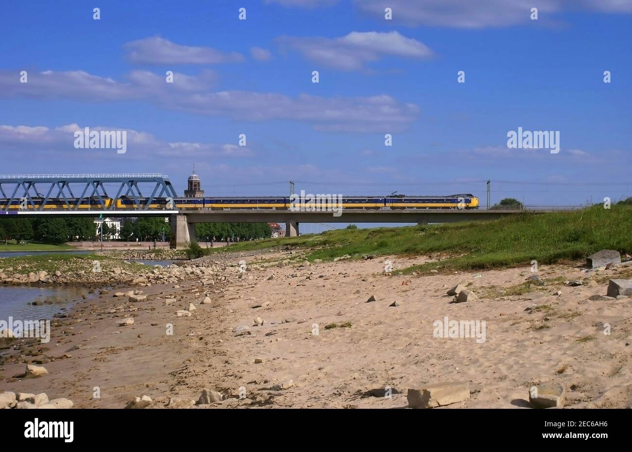 Train on railway bridge crossing river IJssel near Deventer Stock Photo