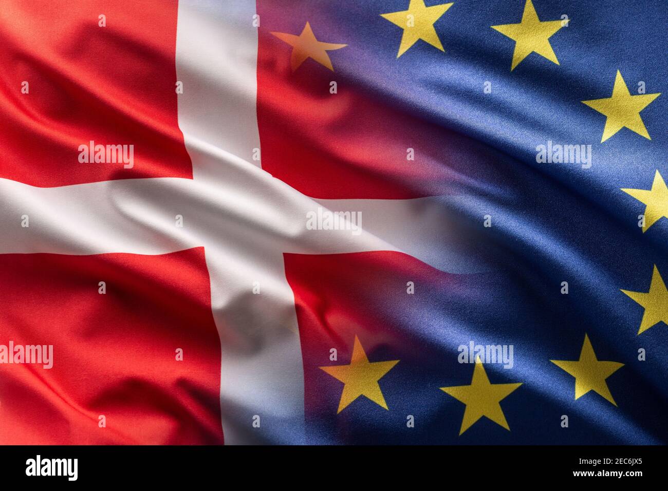 Flags of Denmark and EU blowing in the wind. Stock Photo