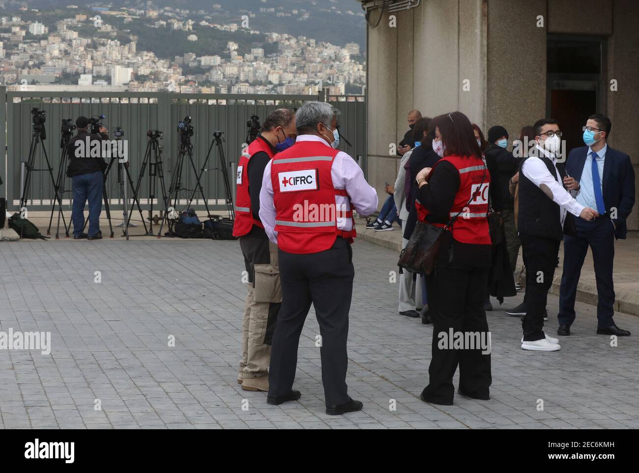 Members of International Federation of Red Cross and Red Crescent Societies  (IFRC) are pictured at Beirut International Airport before the arrival of  the first batch of doses of the Pfizer/BioNTech vaccine against