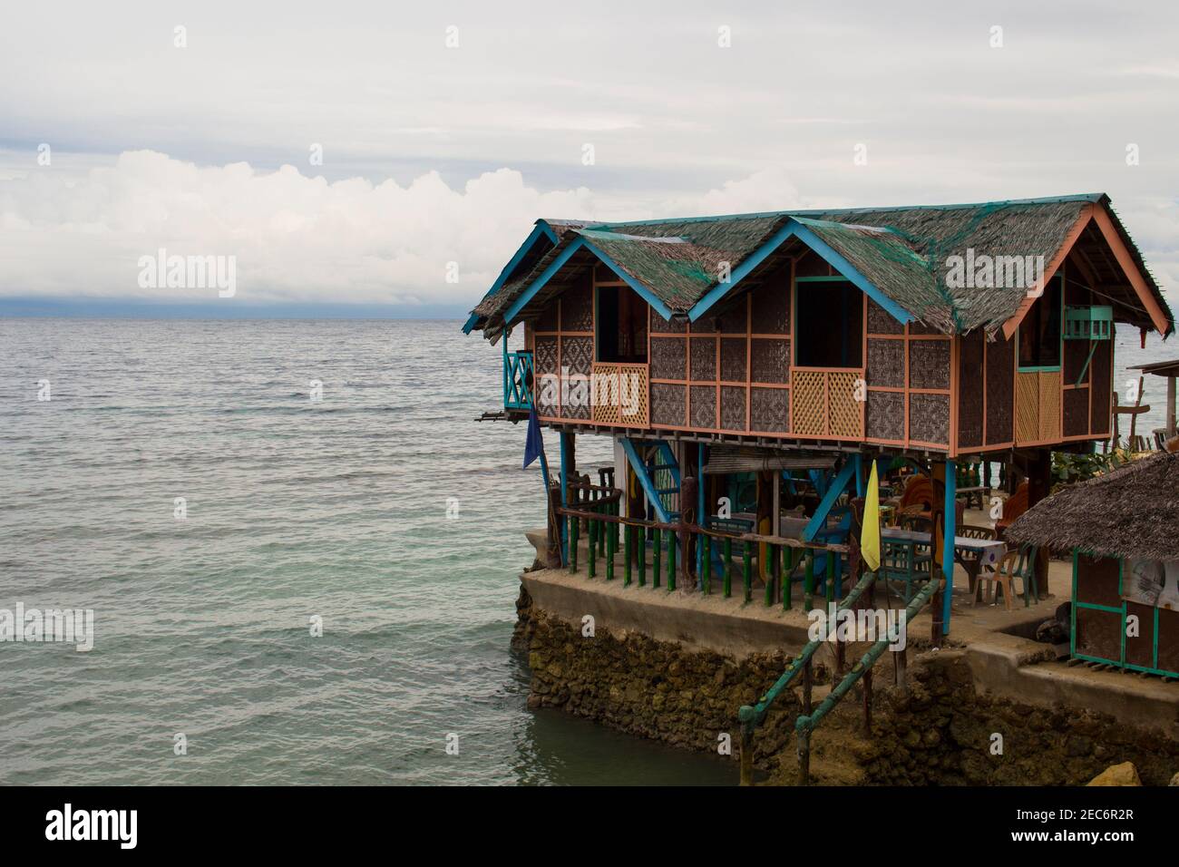Wooden house on piles in shallow sea water. Traditional house in