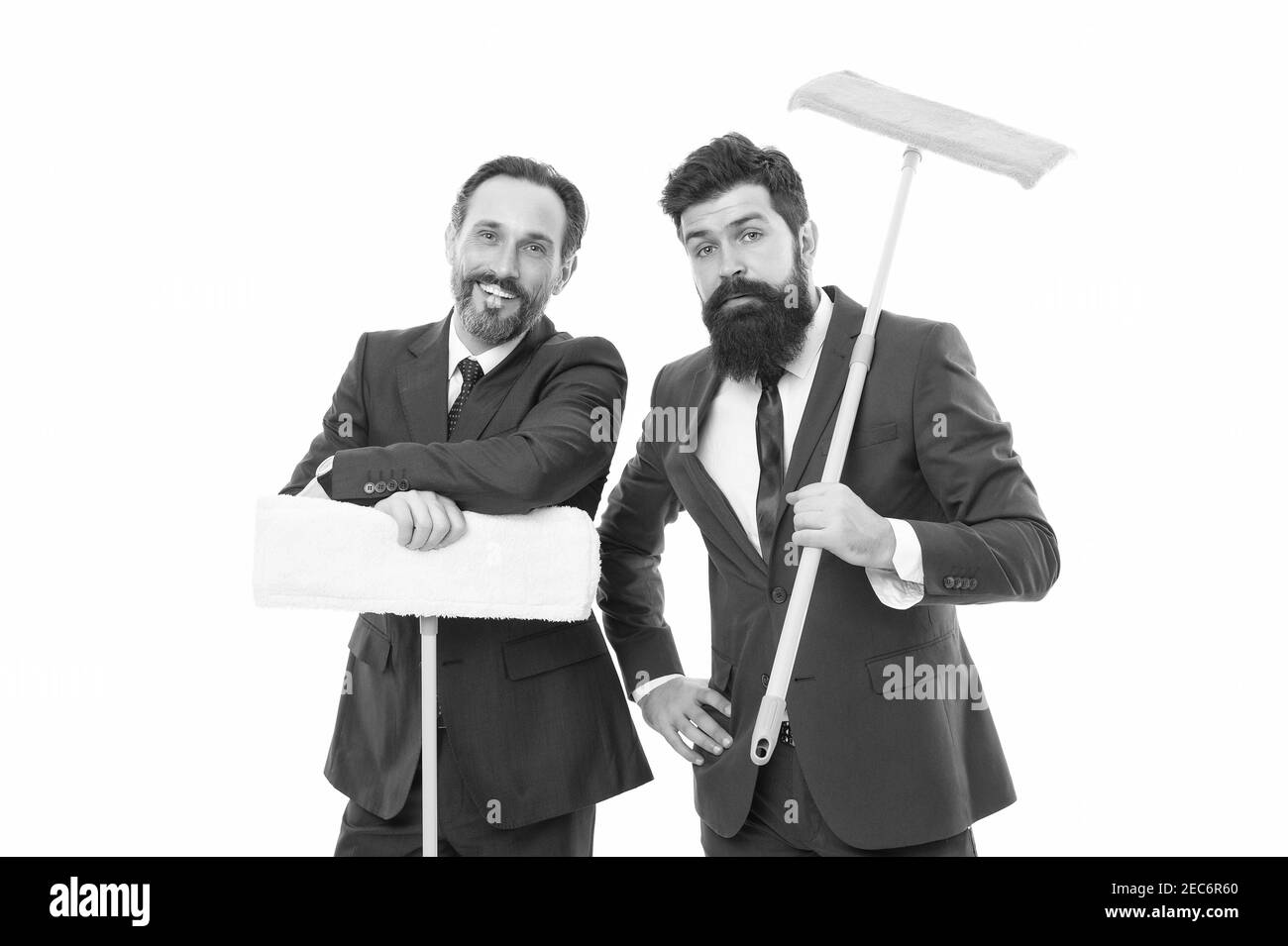 clean slate. cleaning company. clean business. Partnership and teamwork. mature bearded men in formal suit hold householding mop. businessmen clear wall to white. I prepared surprise for you. Stock Photo