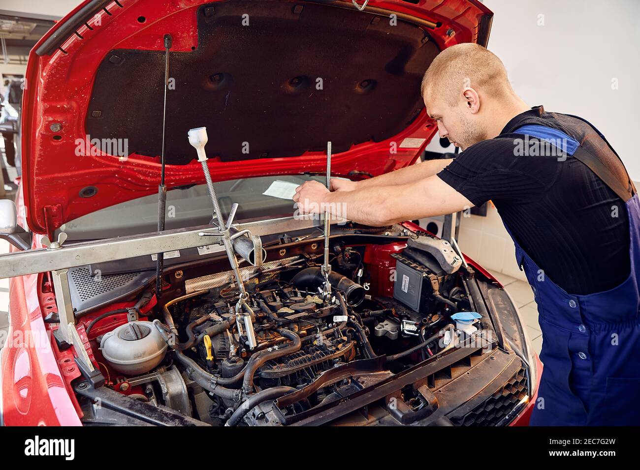 Repairing A Car Engine In Auto service Center Auto Mechanic Working In Repairing A Car Engine In Auto service Center Auto Mechanic Working In