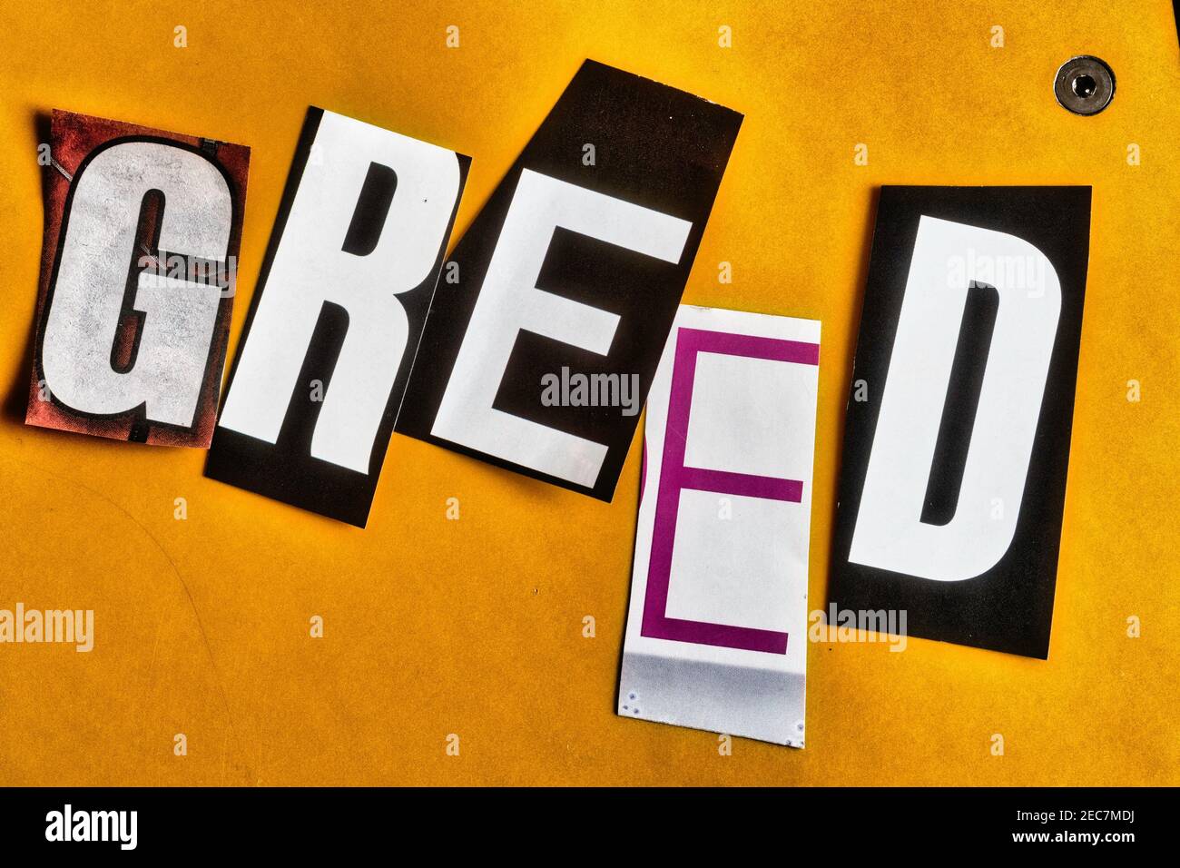 The word "Greed" using cut-out paper letters in the ransom note effect typography Stock Photo