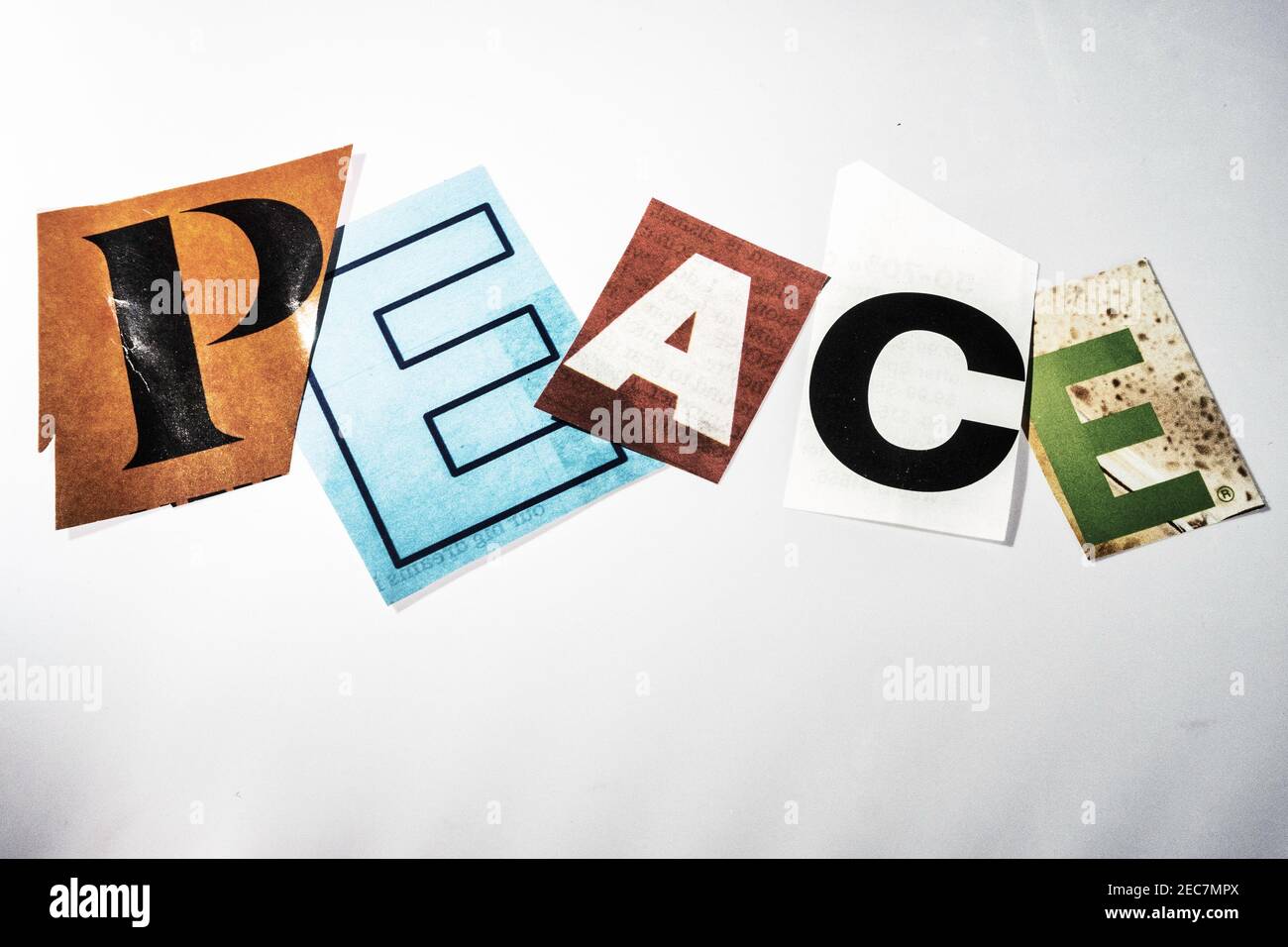 The word Peace on a bulletin board using cut-out paper letters in the ransom note effect typography Stock Photo