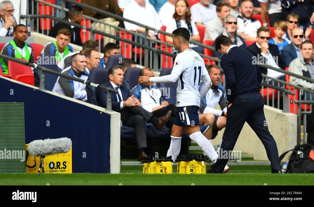 Soccer Football - Premier League - Tottenham Hotspur vs Leicester City - Wembley Stadium, London, Britain - May 13, 2018   Tottenham's Erik Lamela with manager Mauricio Pochettino as he is substituted   REUTERS/Dylan Martinez    EDITORIAL USE ONLY. No use with unauthorized audio, video, data, fixture lists, club/league logos or 'live' services. Online in-match use limited to 75 images, no video emulation. No use in betting, games or single club/league/player publications.  Please contact your account representative for further details. Stock Photo