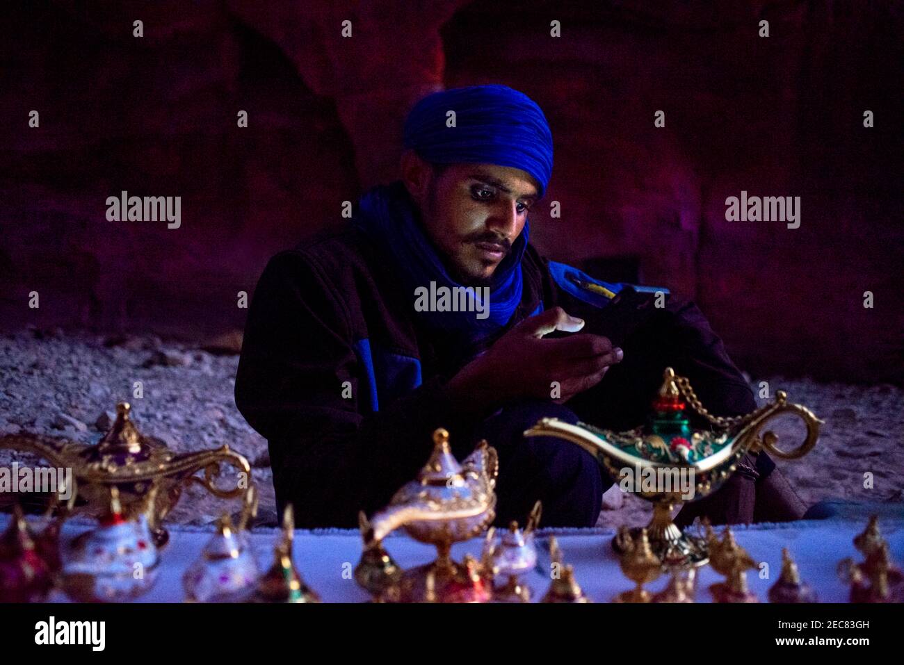 Portrait of a bedouin souvenirs seller at The Treasury, Al Khazneh, at night, Petra, Jordan.   Petra is a historical and archaeological city in the so Stock Photo