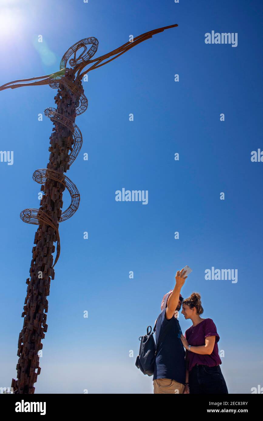 Tourist couple in The memorial cross at Mount Nebo, Jordan Stock Photo
