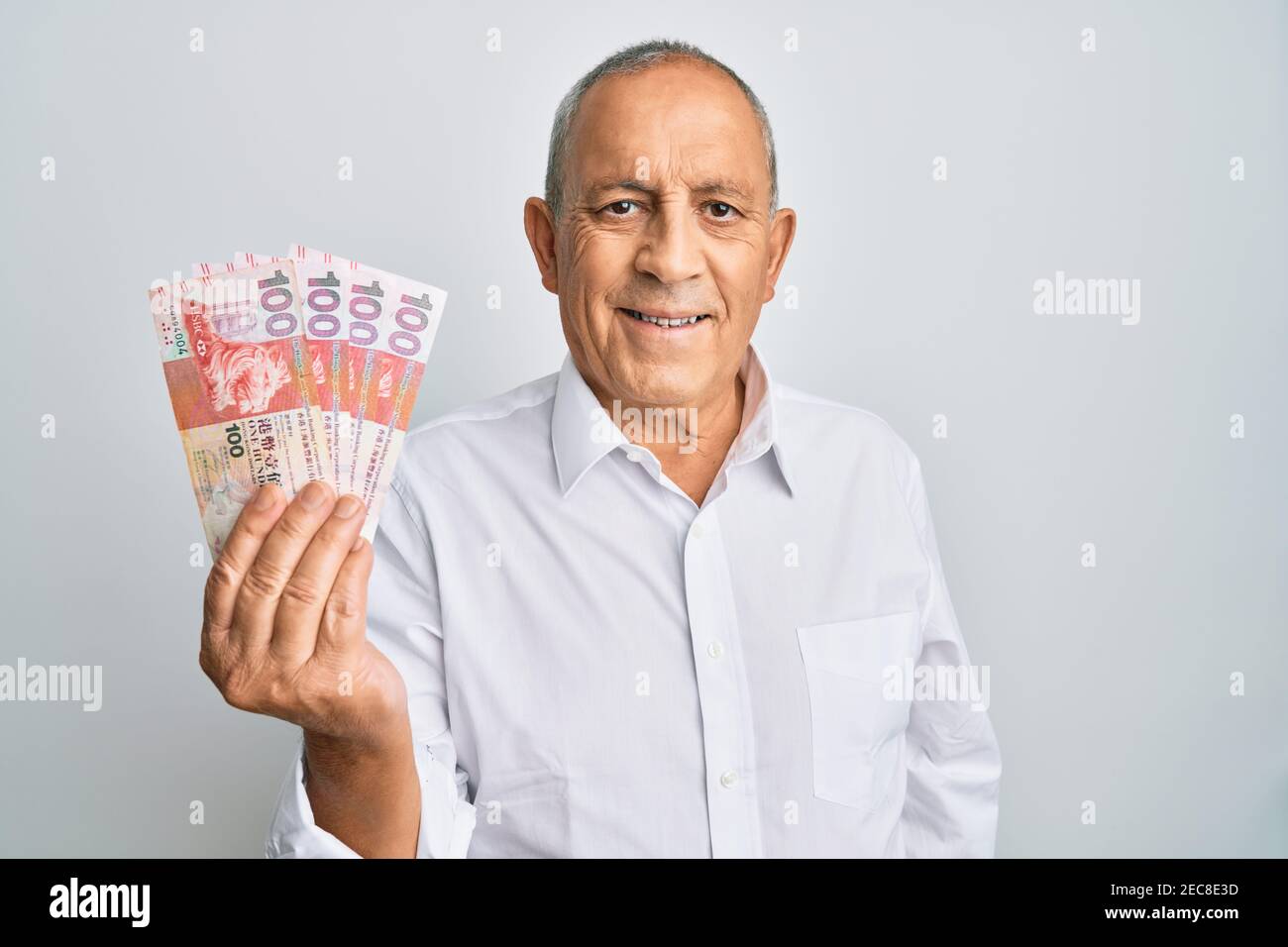 Handsome Senior Man Holding 100 Hong Kong Dollars Banknotes Looking handsome-senior-man-holding-100-hong-kong-dollars-banknotes-looking