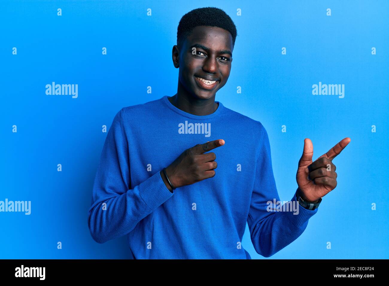 Young african american man wearing casual clothes smiling and looking ...