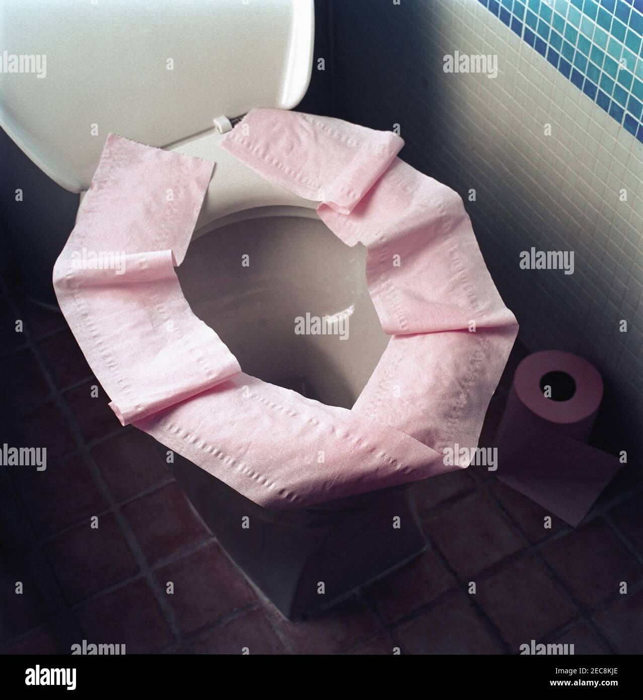 toilet seat covered with toilet paper as a precaution against disease