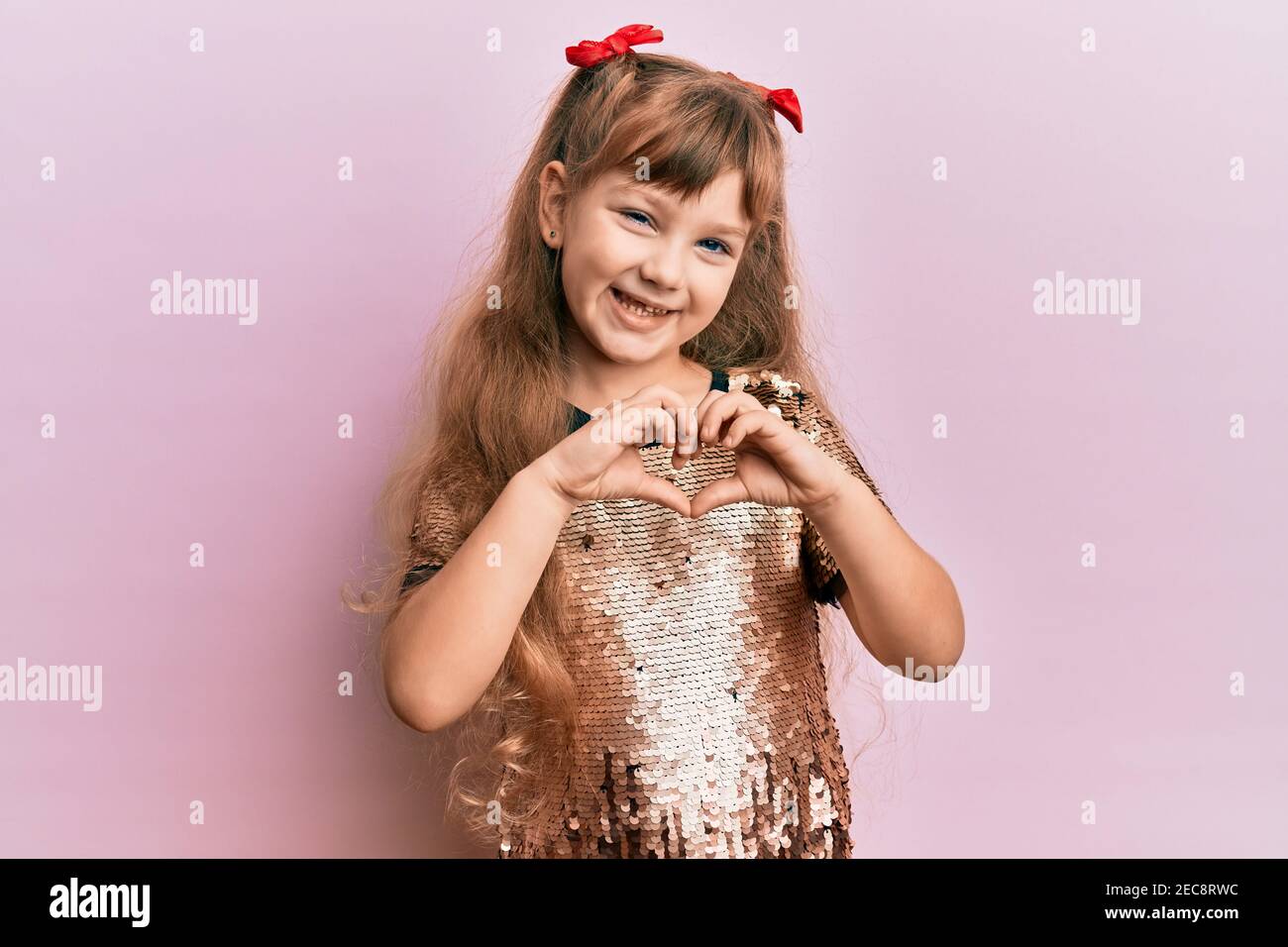 Little caucasian girl kid wearing festive sequins dress smiling in love ...