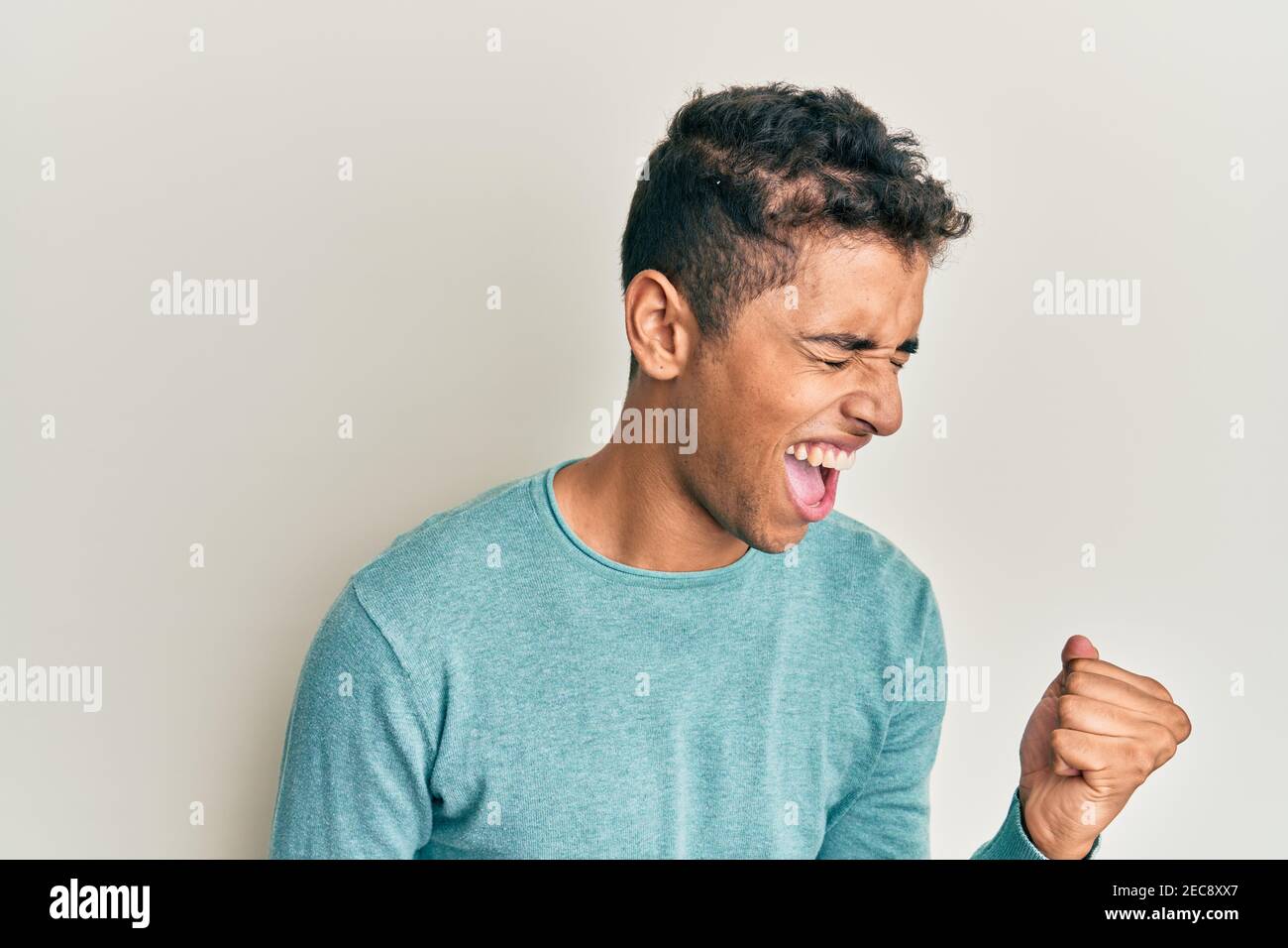 Young handsome african american man wearing casual clothes celebrating ...