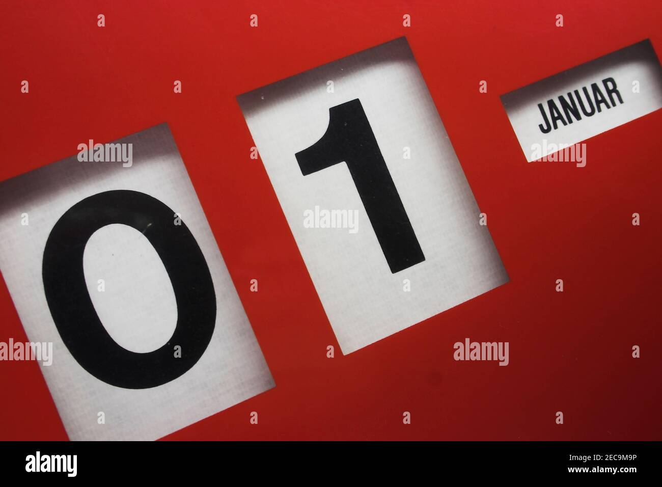 Old red rotating Calender set to 01. January in german letters Stock