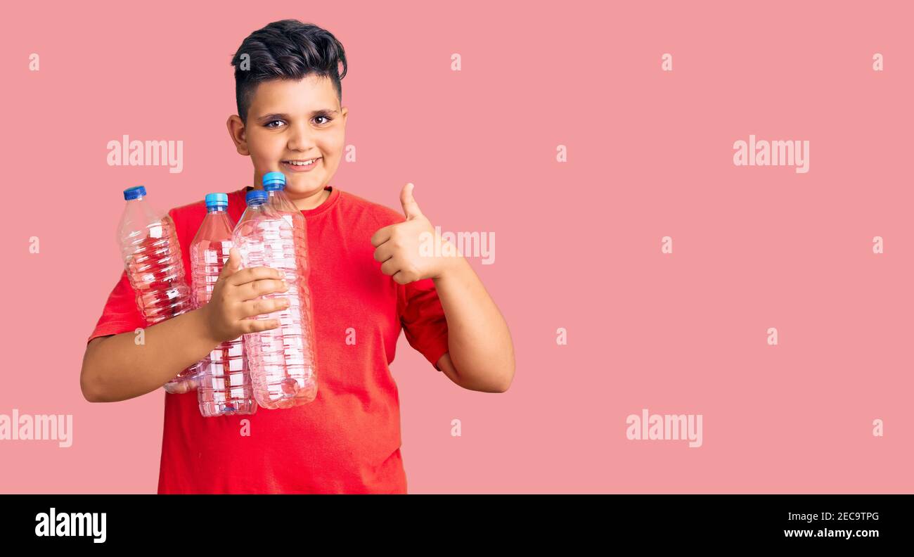 Little boy kid holding recycling plastic bottles smiling happy and ...