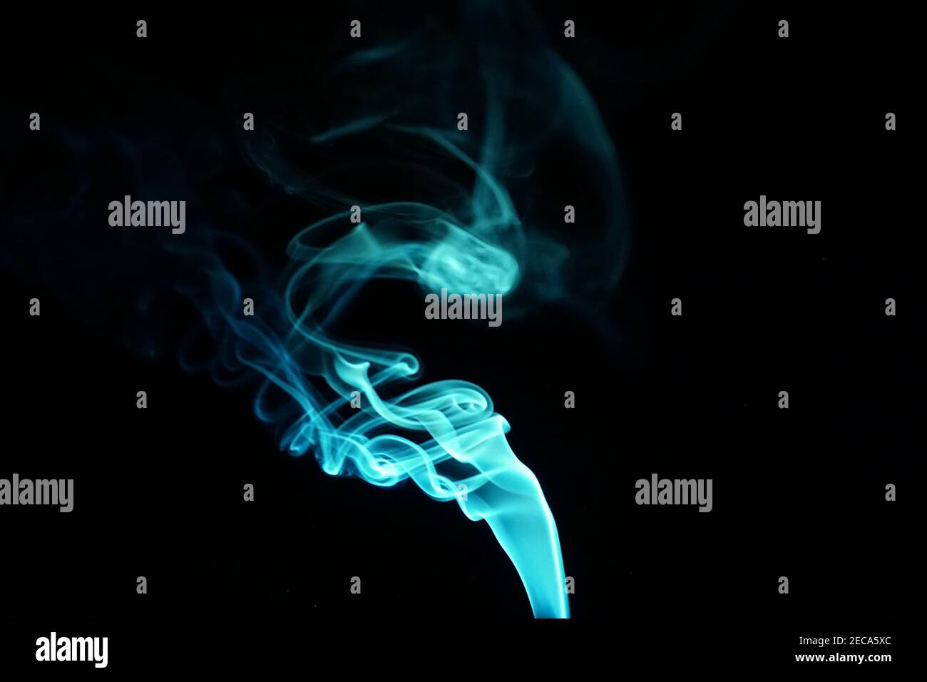Cloud of abstract blue smoke in front of a black background Stock Photo ...