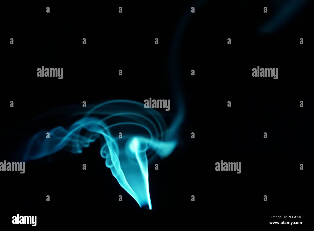 Cloud of abstract blue smoke in front of a black background Stock Photo ...
