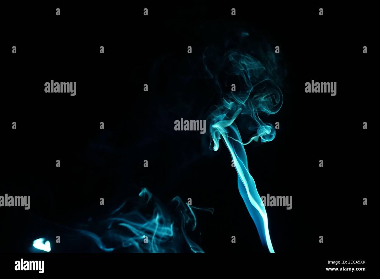 Cloud of abstract blue smoke in front of a black background Stock Photo ...