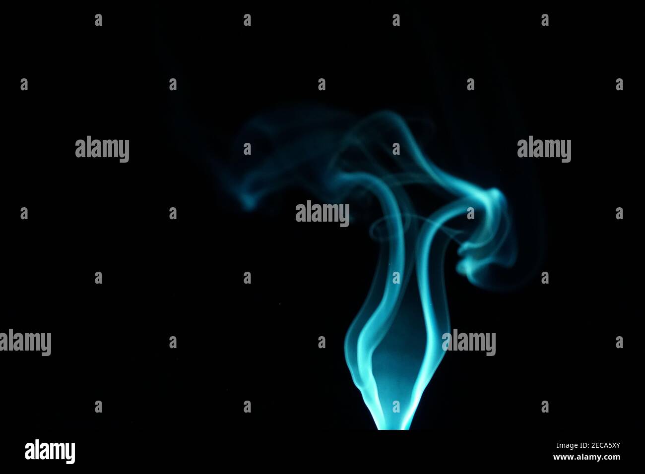 Cloud of abstract blue smoke in front of a black background Stock Photo ...