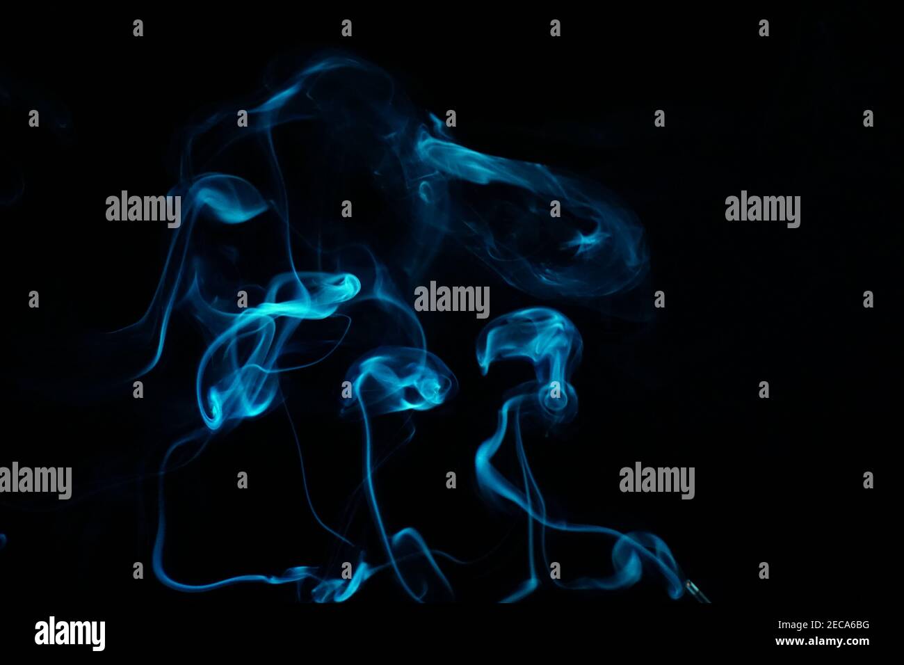 Cloud of abstract blue smoke in front of a black background Stock Photo ...
