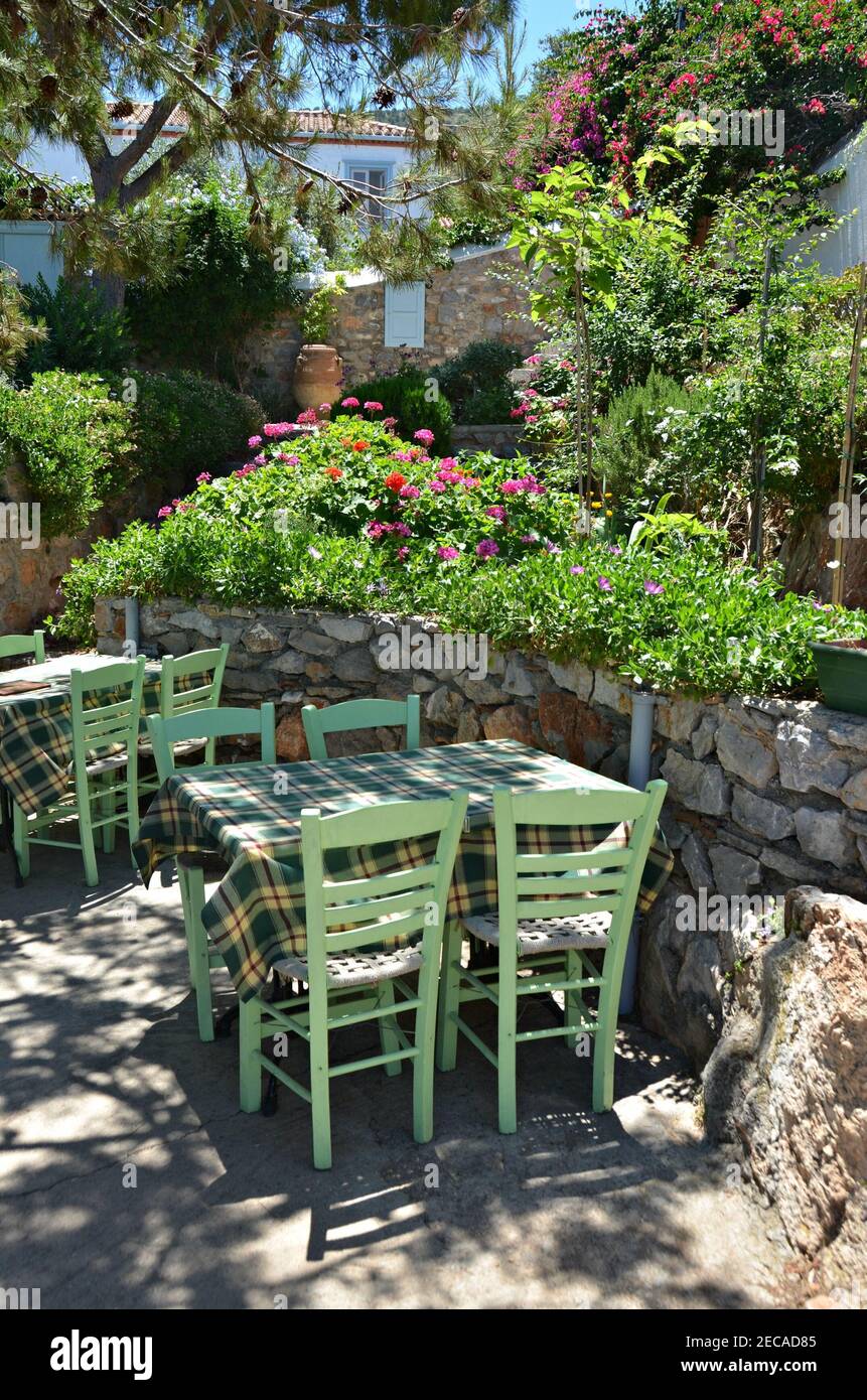 Taverna patio with bistro tables covered by green checkered tablecloths