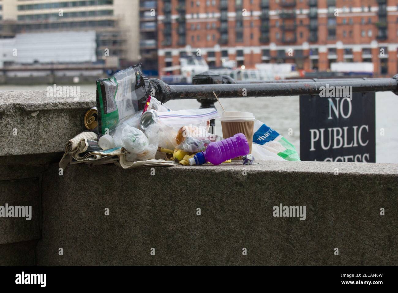 Rubbish and litter left on a wall by the Thames in London. No Public