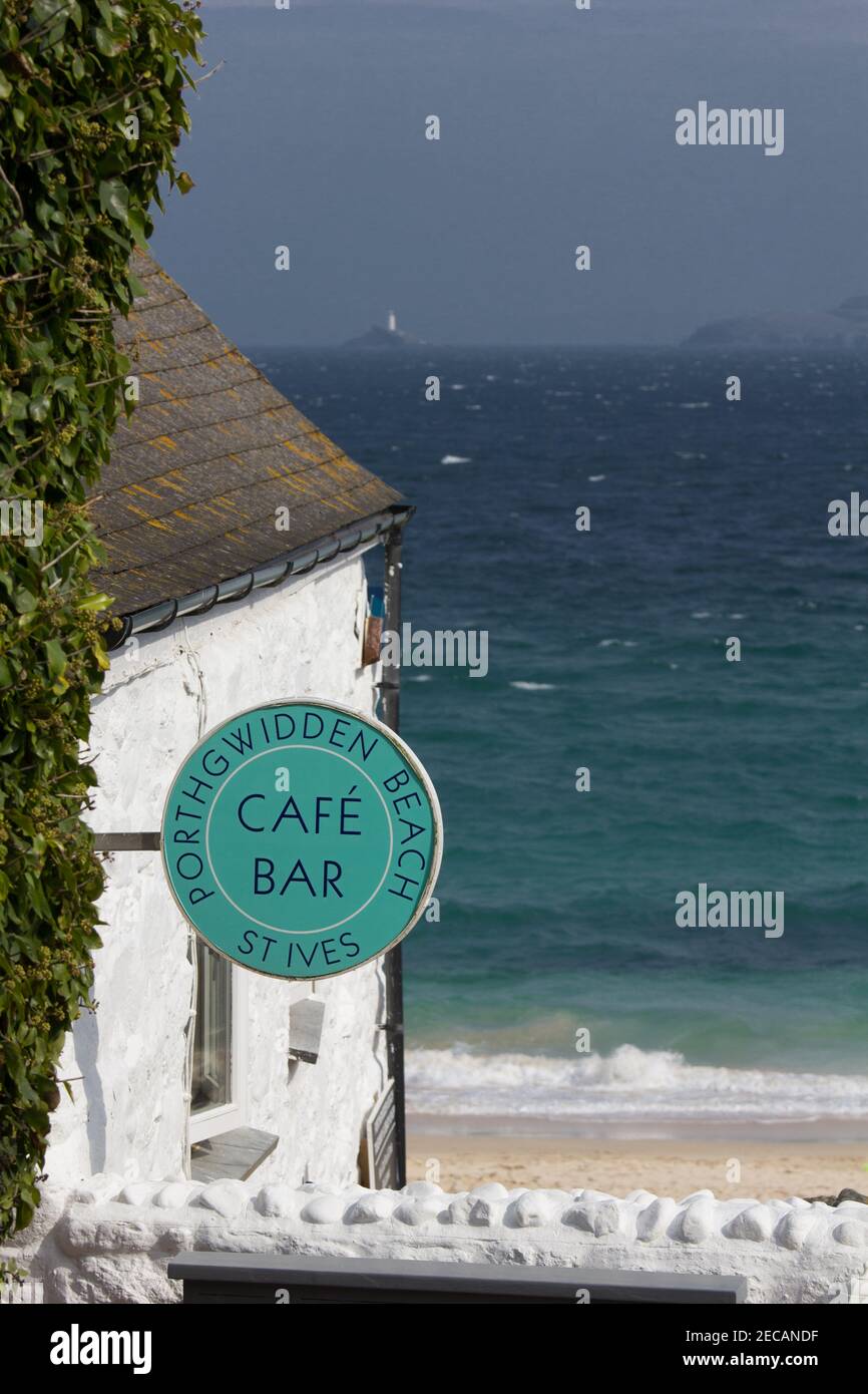Porthgwidden café overlooking Porthgwidden beach at St Ives, Cornwall.  Godrevy lighthouse at Godrevy Point in the distance across the bay. Stock Photo