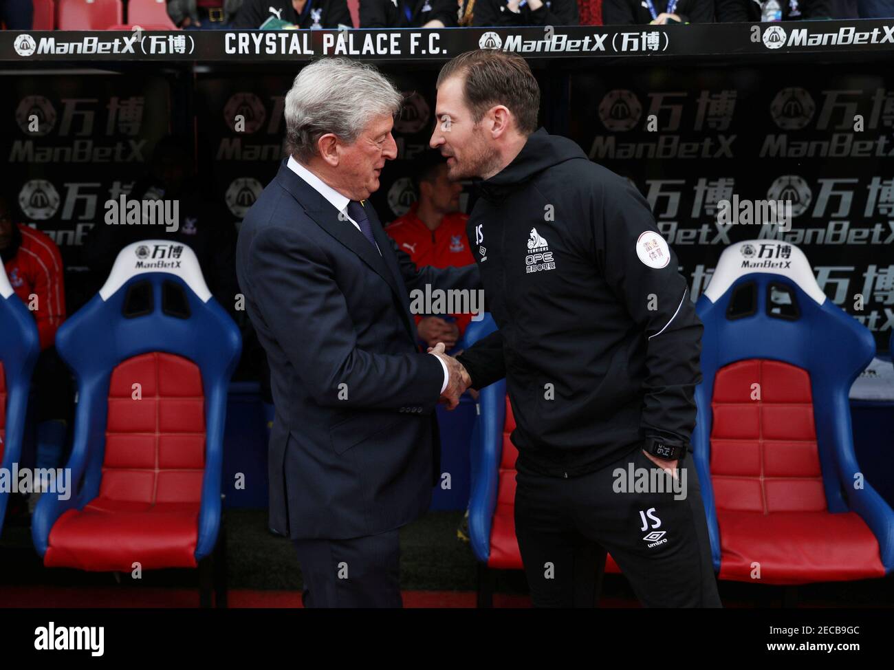 Soccer Football - Premier League - Crystal Palace v Huddersfield Town - Selhurst Park, London, Britain - March 30, 2019  Crystal Palace manager Roy Hodgson shakes hands with Huddersfield Town manager Jan Siewert before the match    REUTERS/Hannah McKay  EDITORIAL USE ONLY. No use with unauthorized audio, video, data, fixture lists, club/league logos or "live" services. Online in-match use limited to 75 images, no video emulation. No use in betting, games or single club/league/player publications.  Please contact your account representative for further details. Stock Photo