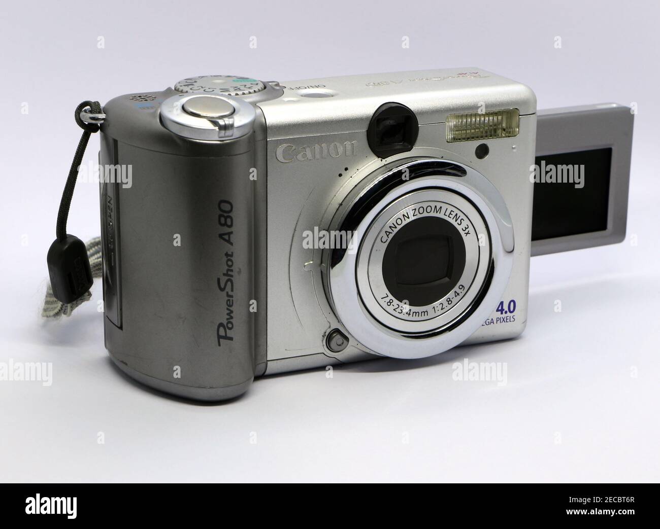 Photo of a Canon Powershot A80 digital 4.0 Mega Pixel small silver camera with flip out LCD screen and 7.8-23.4 mm zoom lens on a white background Stock Photo