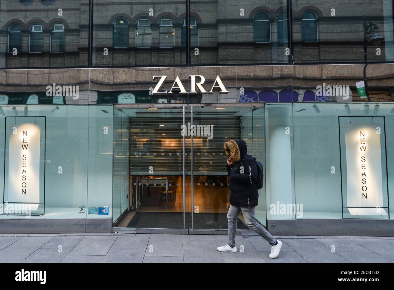Dublin, Ireland. 12th Feb, 2021. A person walks by a closed ZARA store in  Dublin city center, during the COVID-19 pandemic lockdown.Level 5 lockdown  restrictions are set to be extended by Irish