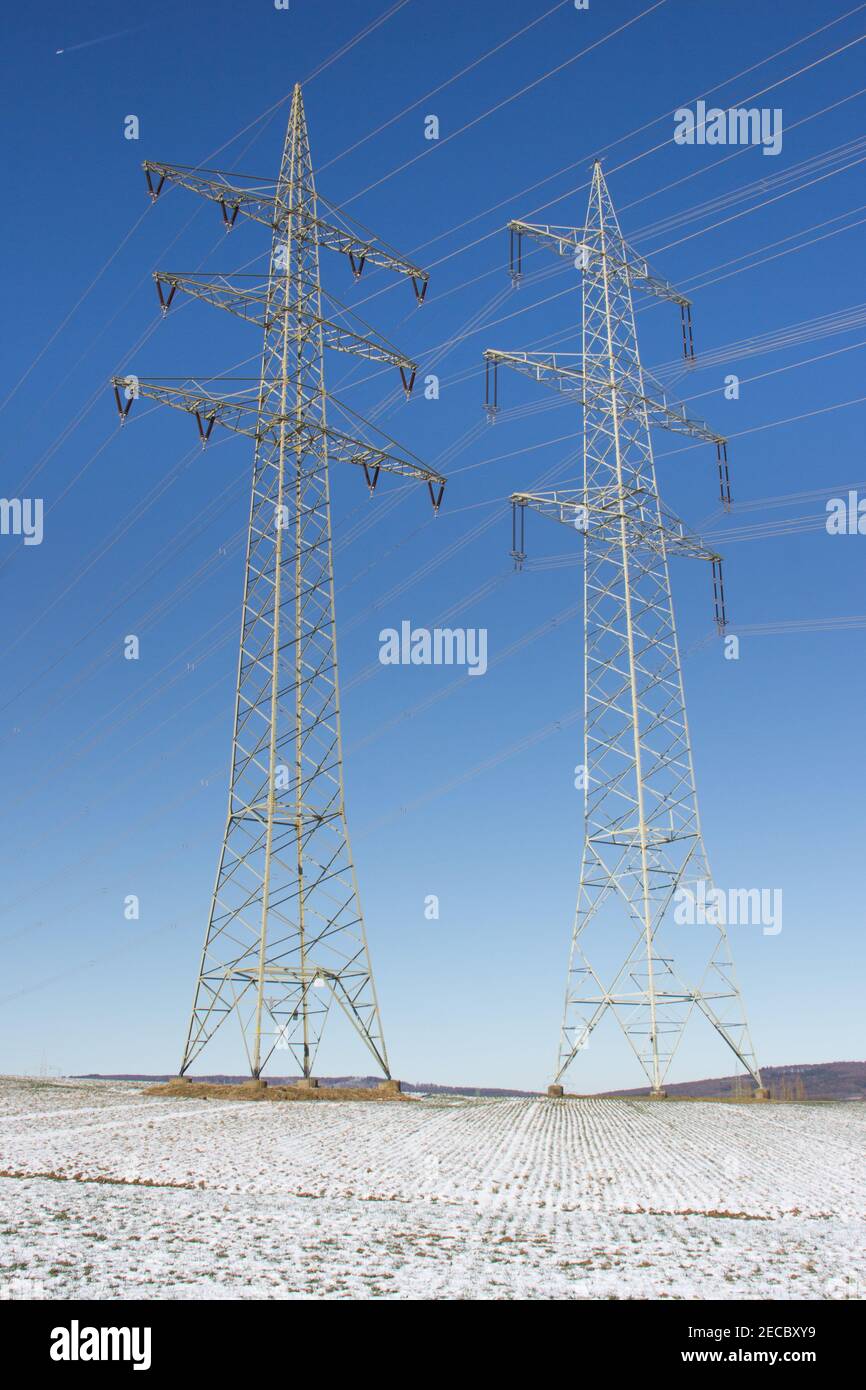 Two Electricity pylons in the winter landscape with snow field Stock ...
