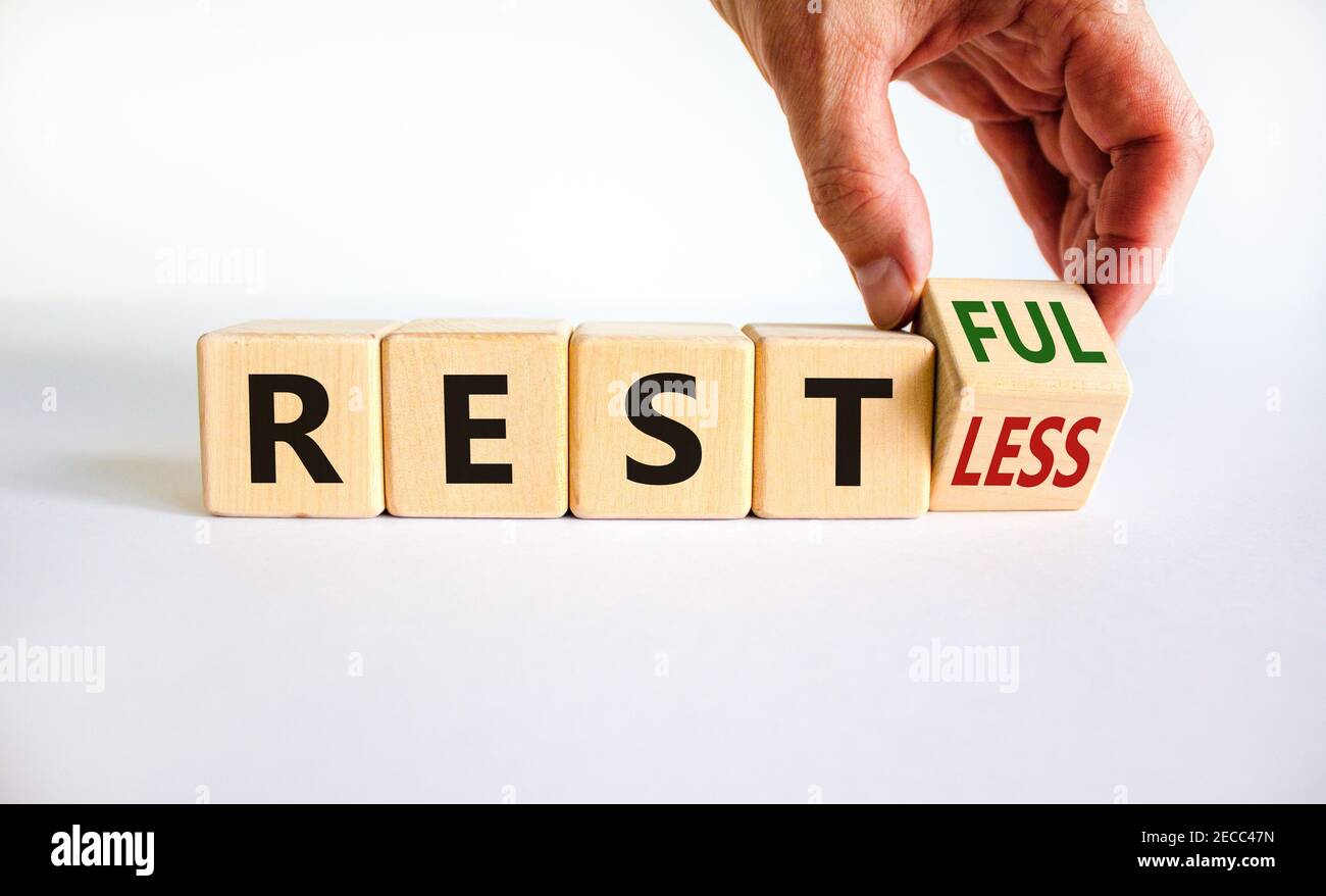 Restless or restful symbol. Businessman turns the wooden cube, changes ...