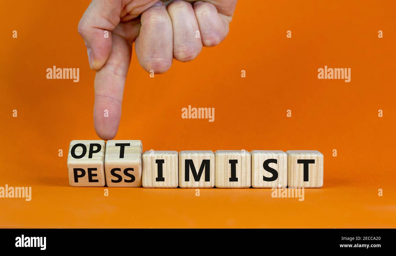 Pessimist or optimist symbol. Businessman turns cubes and changes the word  'pessimist' to 'optimist'. Beautiful orange table, orange background. Busin  Stock Photo - Alamy, image size:1300x841