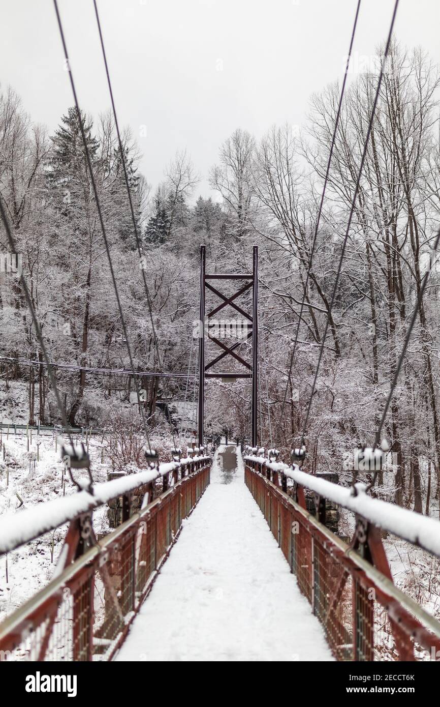 The Grist Mill Walking Bridge in a snowstorm. Stock Photo