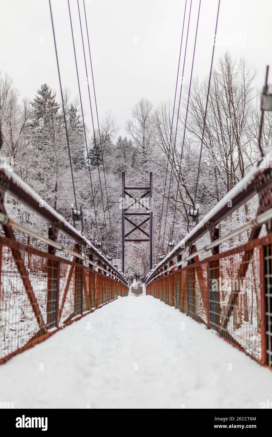 The Grist Mill Walking Bridge in a snowstorm. Stock Photo