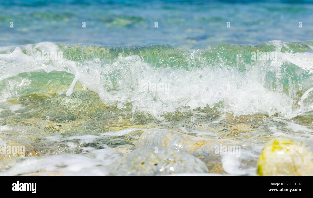 Pibble Wave Sea wave and pebble. Summer vacation concept. Sea wave with foam ...