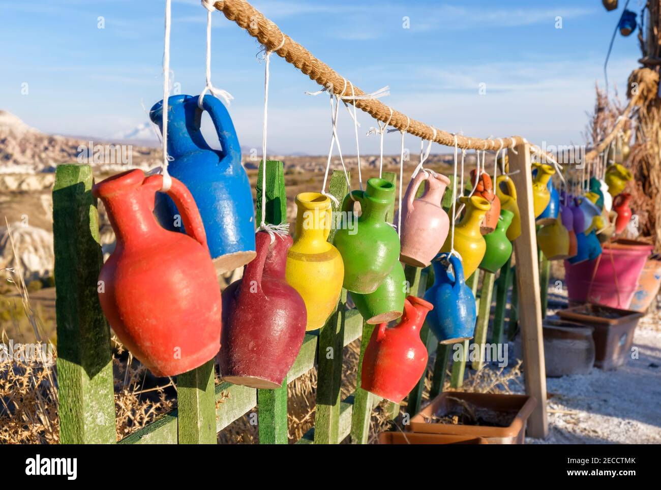 Multicolored decorative old jugs on wood, Cappadocia, Turkey. Stock Photo