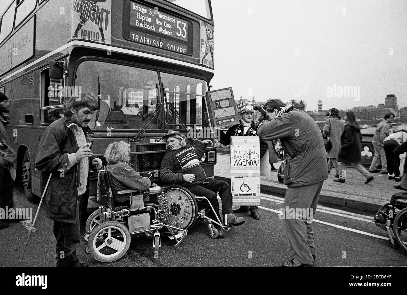 Wheelchair users Barbara Lisicki and Alan Holdsworth from DAN (Disabled Action Network) handcuff themselves to a London bus on Westminster Bridge, London in  February 1995 as part of a series of protests about lack of disabled persons access to public transport, in the lead up to the Disability Discrimination Act being debated in Parliament. Stock Photo