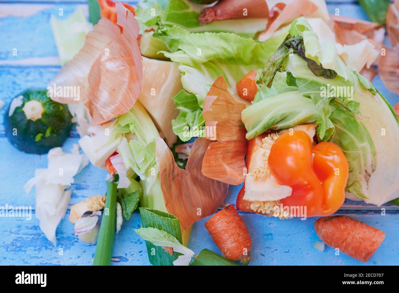 close up of organic waste from vegetables on blue background, view from top Stock Photo