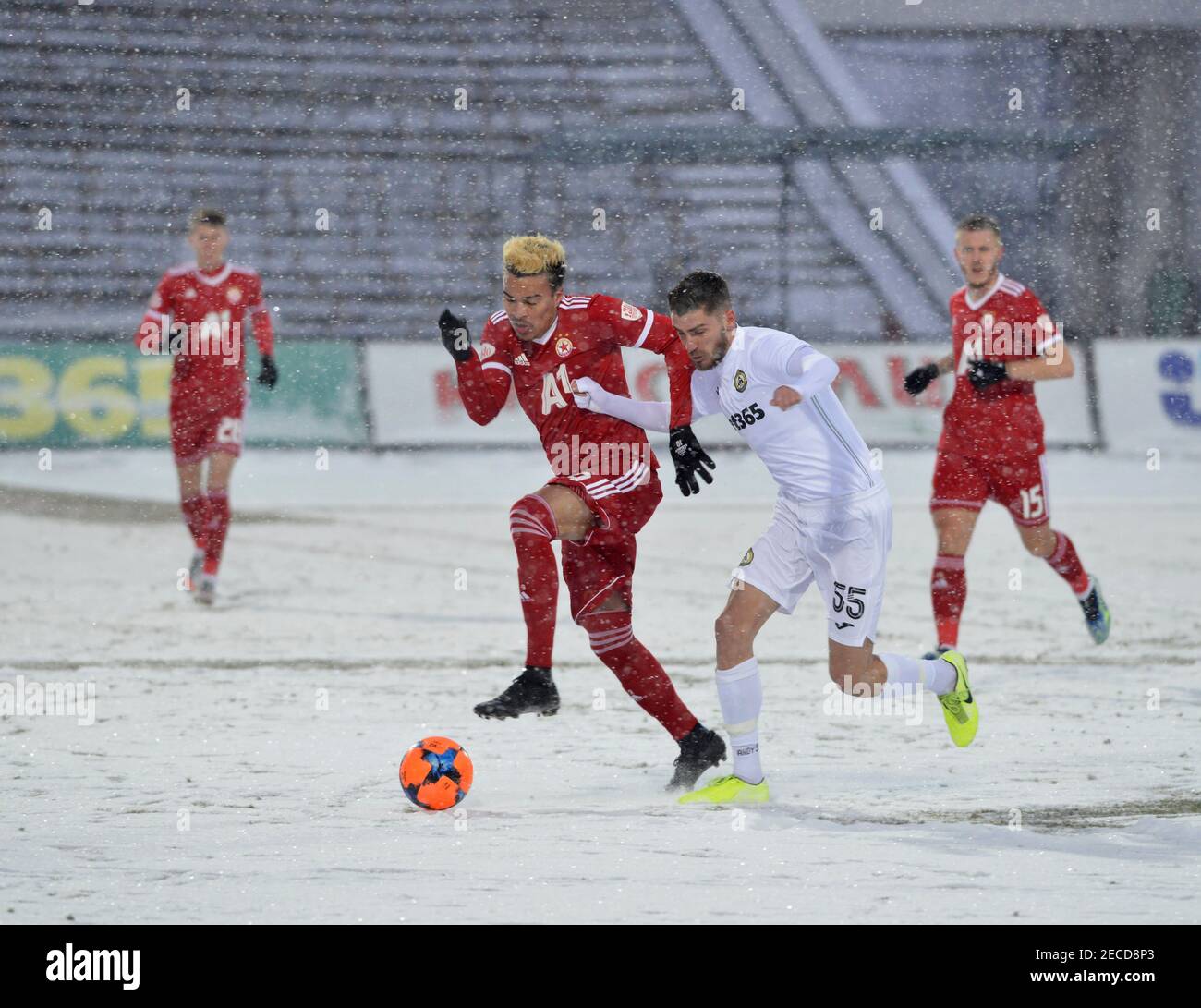 Sofia, Bulgaria - Feb 13 2021: Penaranda and Hristov fighting for the ball during a snowy football match between CSKA Sofia and Slavia Stock Photo