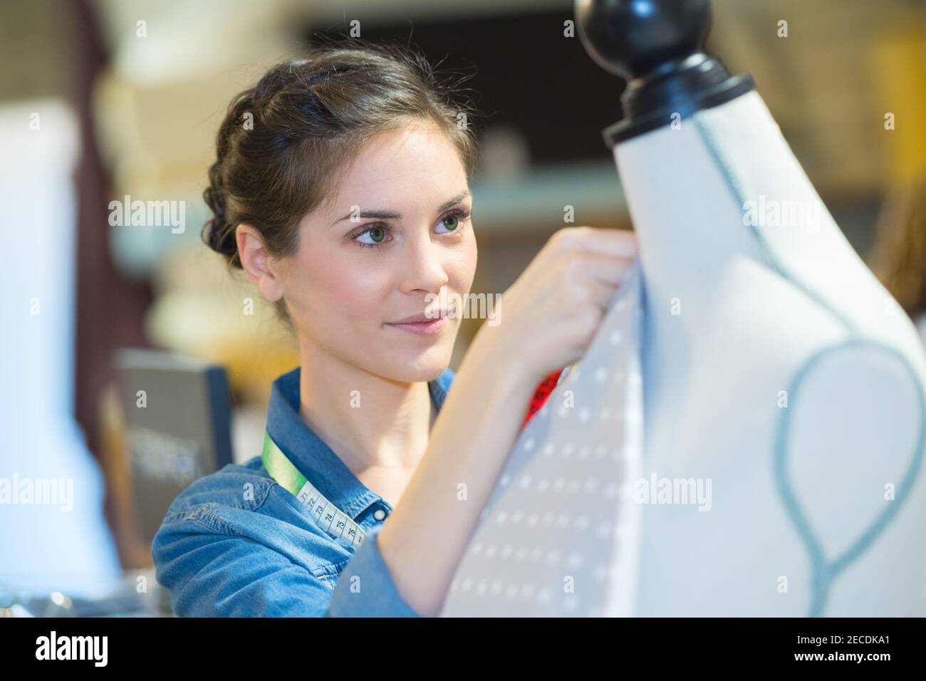 dressmaker working with fabric on mannequin Stock Photo Alamy