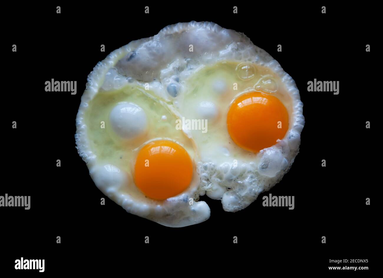Two fried eggs Isolated on a black background view from above. With clipping path Stock Photo