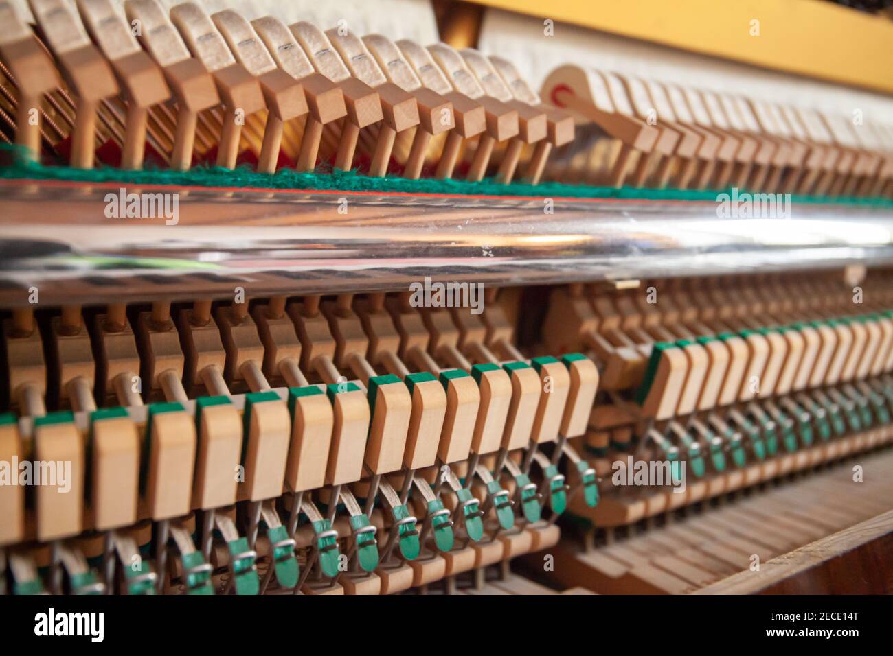 Open upright piano. Piano action close up. German piano action, internal mechanism. Piano tuning, repair and maintenance. Hammers. Stock Photo