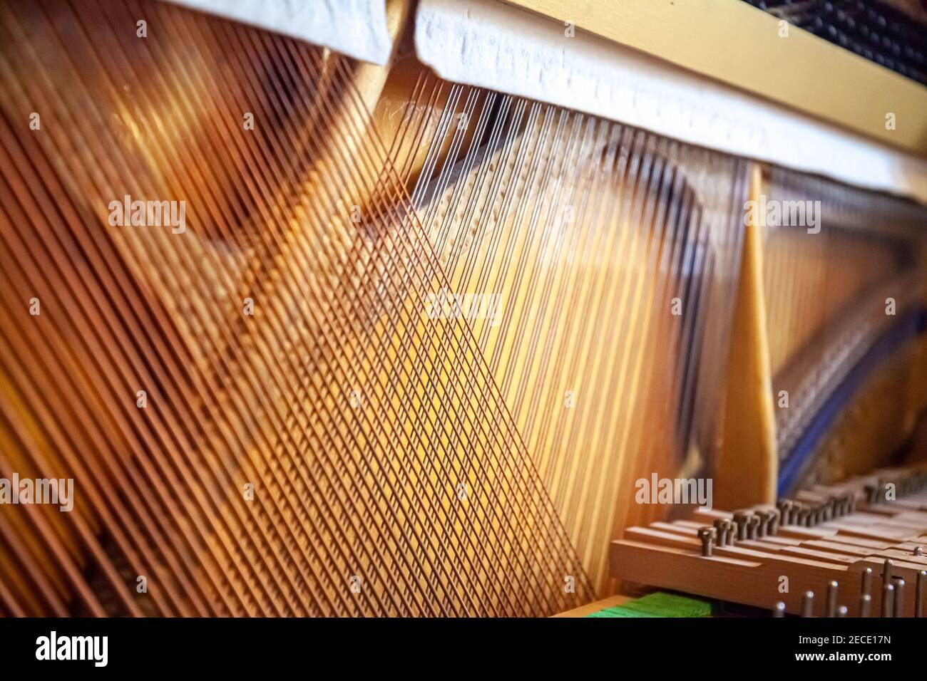 Upright piano strings. Open piano. Piano sound board. Piano frame. Copper strings. Piano service. Stock Photo