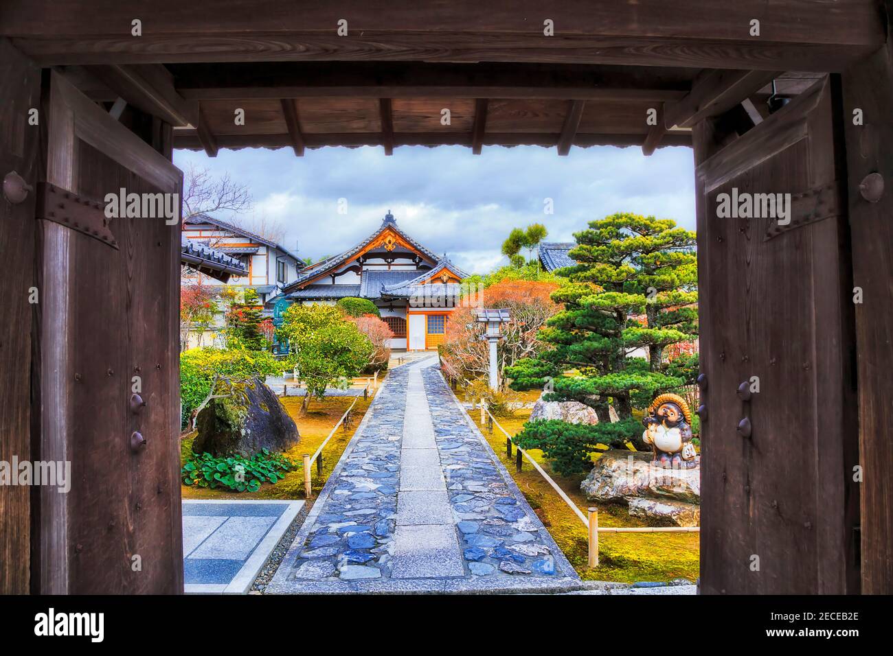 Frame of welcoming open gates at the entrance to traditional japanese garden with historic temple and park in Kyoto city of Japan. Stock Photo
