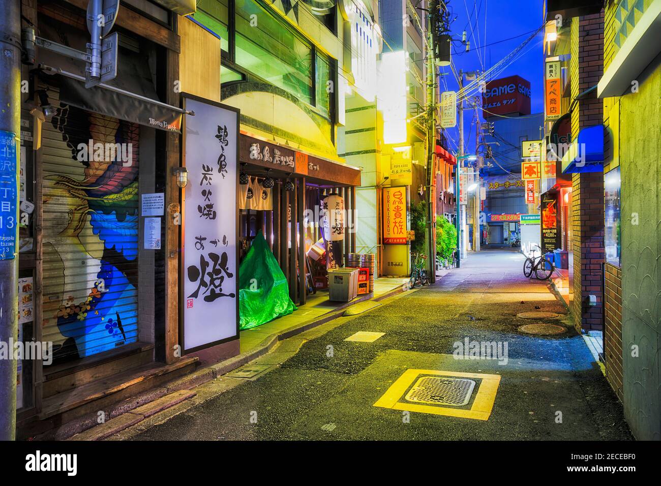 Tokyo, Japan - 2 January 2020: Quiet back street of shopping district in Shimokitazawa part of Greater Tokyo city at sunrise with bright lights and no Stock Photo