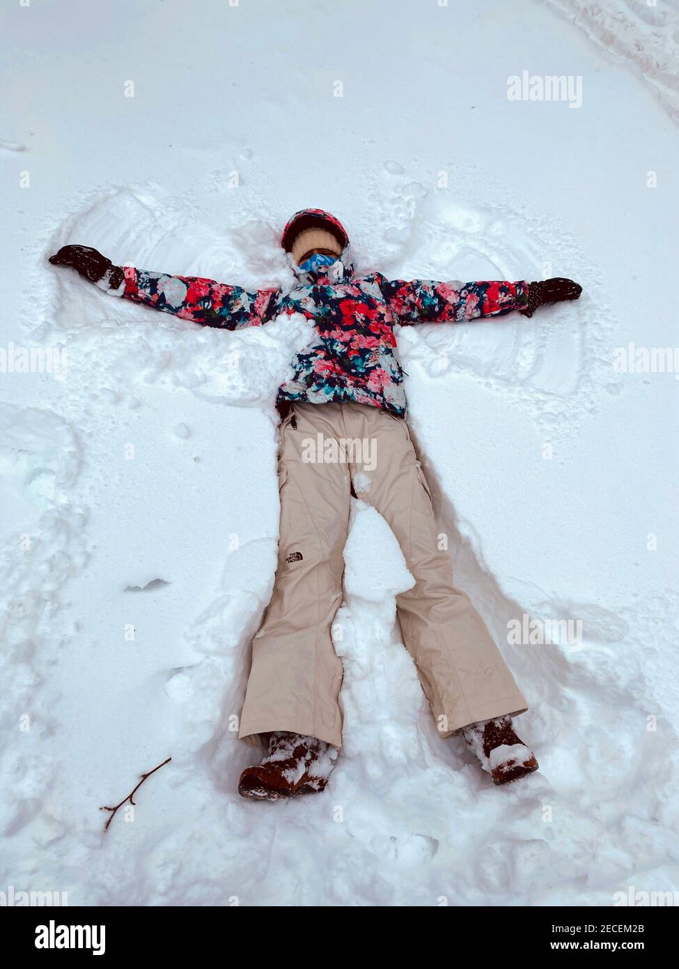 Snow angel with a face mask during the Covid-19 pandemic in Brooklyn, New York. Stock Photo