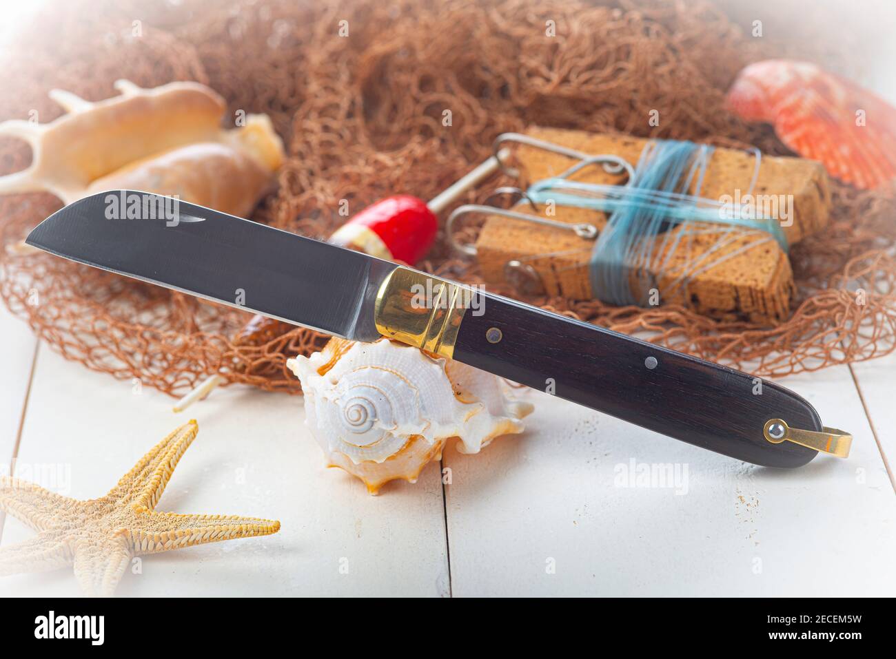 Vintage still life about fishing with a pipe and a sailor knife Stock Photo  - Alamy