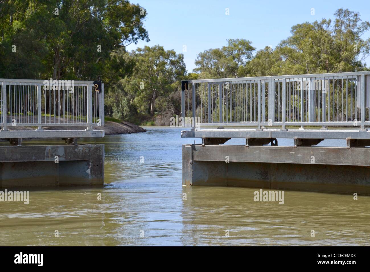 Hydraulic mechanical gates at Lock 11 on the Murray River near Mildura opening to allow a boat to pass upstream or downstream Stock Photo